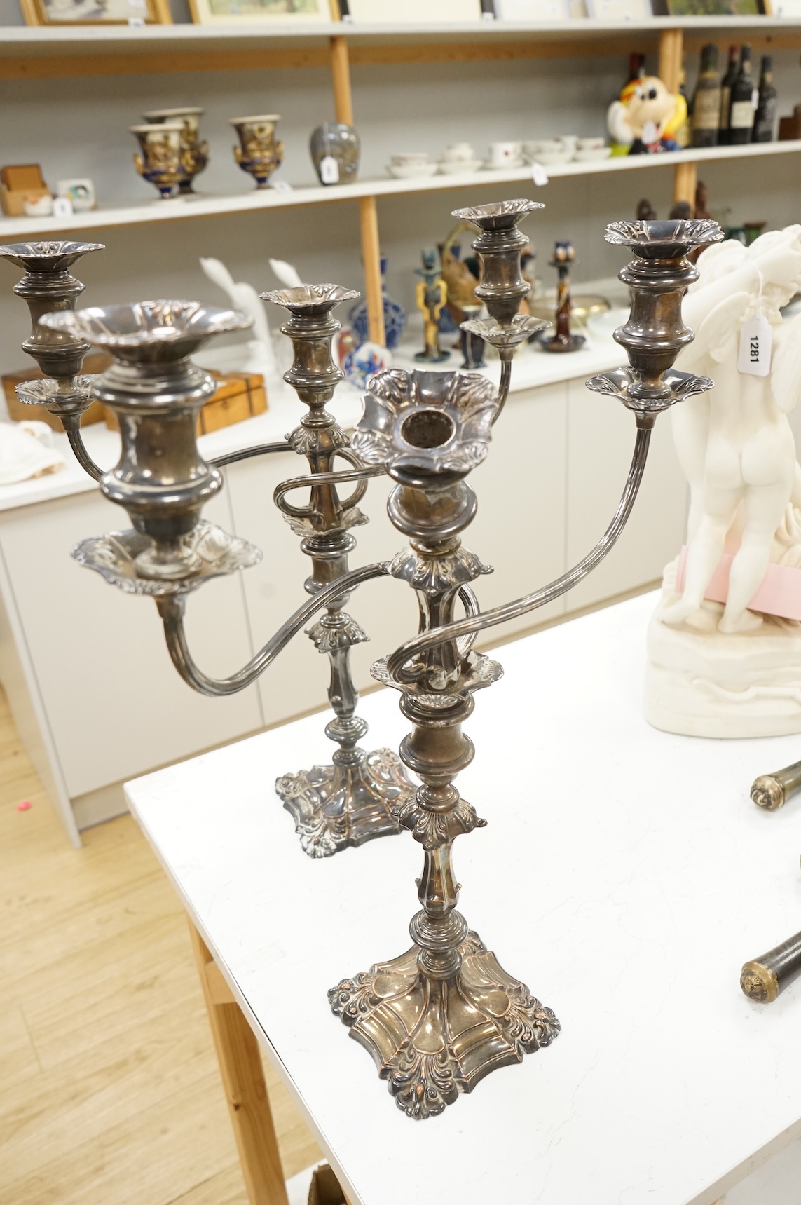 A pair of silver plated two branch three light candelabra, 53cm high
